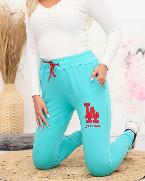 Женские бирюзовые спортивные штаны с цветной нашивкой - Одежда